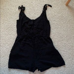 Black cotton romper with slightly open back.